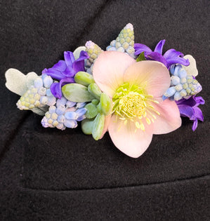 A wonderful pocket square made with fresh spring blooms such as, muscari, hyacinth, hellebore, and accented with dusty miller and a succulent.